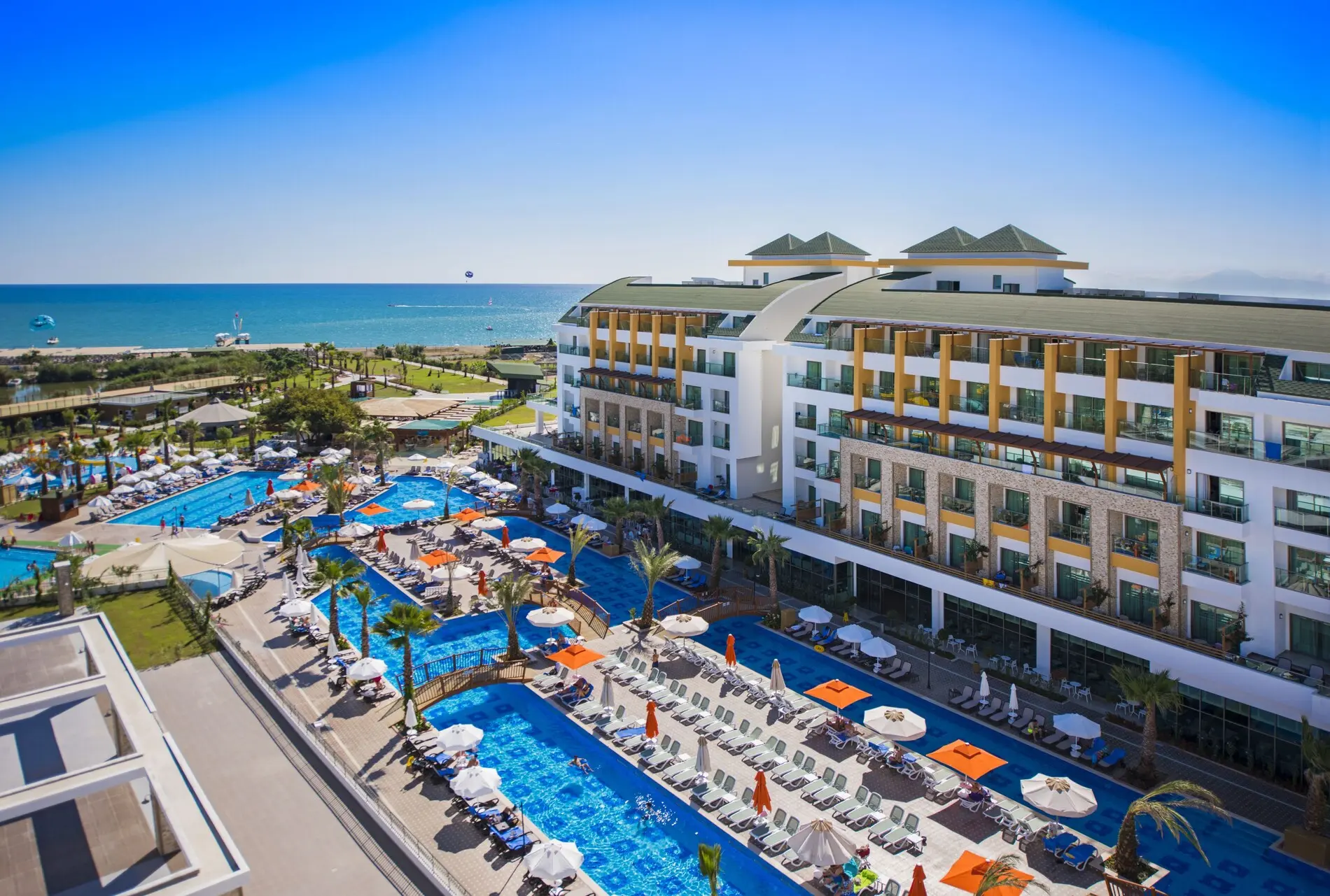 Главната сграда с басейните и морето зад нея – Port Nature Luxury Resort Hotel & SPA, Белек