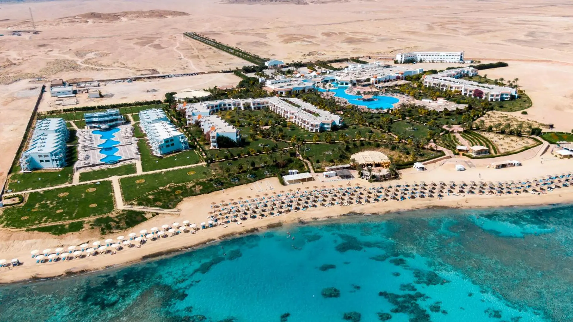 Нискоетажният комплекс в пустинята с плажа и тюркоазената лагуна отгоре – Fantazia Resort Marsa Alam, Марса Алам