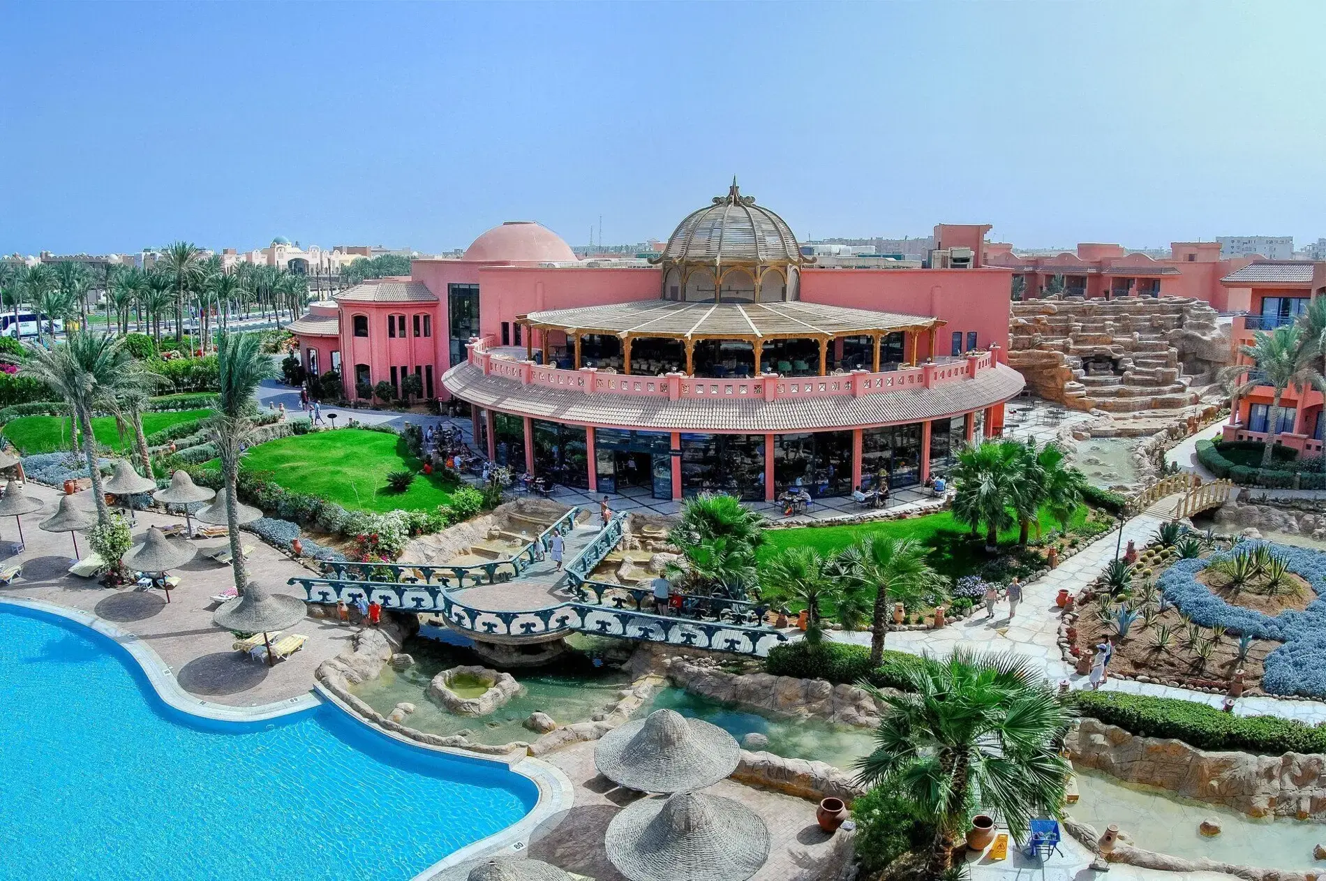 Панорама към розовите сгради, ресторанта с купол и басейна – Parrotel Aqua Park Resort, Шарм Ел Шейх