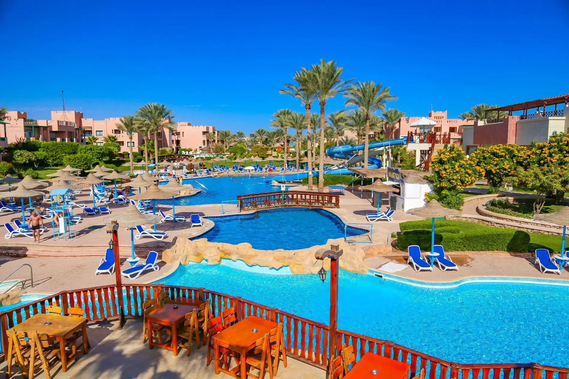 Басейни сред палми под синьо небе, гледка от терасата – Rehana Sharm Resort Aquapark & Spa, Шарм Ел Шейх